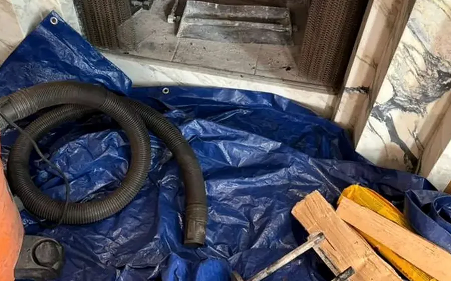 Fireplace set up for a chimney sweep with floor protection and a vacuum