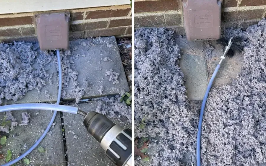 Outside dryer vent hood with lint and a cleaning brush